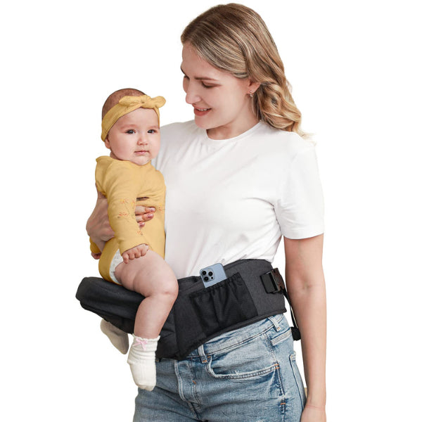 A new mom securely holds her baby in the Baby and Toddler Hip Seat Carrier
