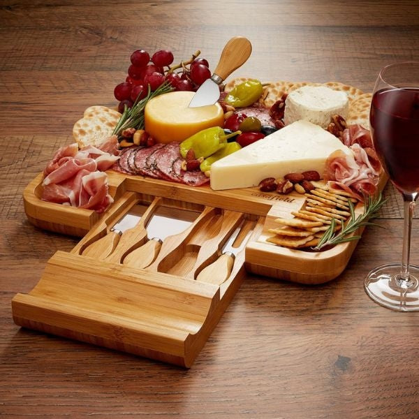 Elegant bamboo cheese cutting board and knife set, perfect New Year's Eve hostess gift.