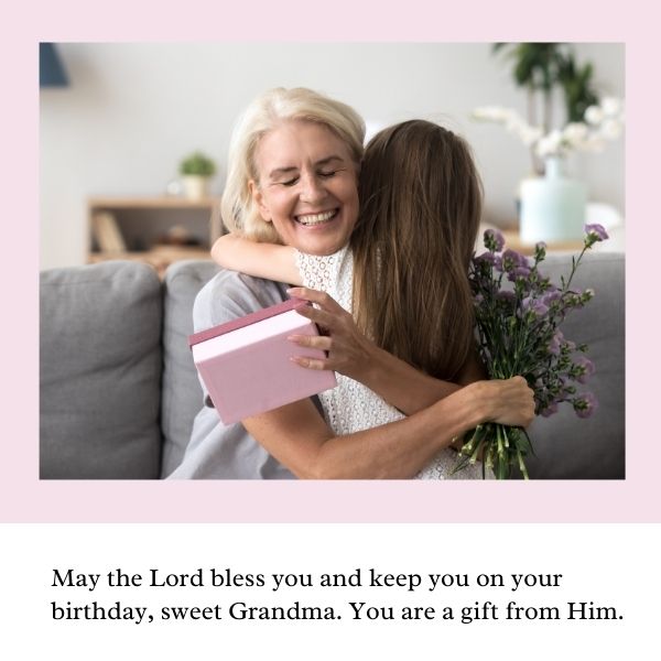Grandmother and granddaughter hugging with a birthday blessing on a cozy background.