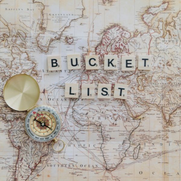 Vintage map with a compass and 'BUCKET LIST' spelled out in letter tiles.