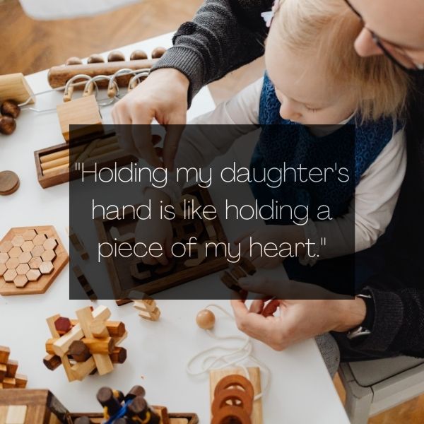 Adorable father-daughter duo with a heartwarming quote displayed.