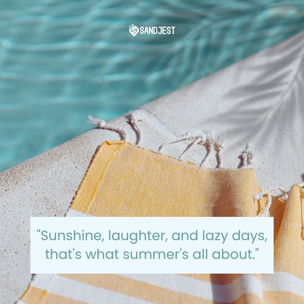 The image features a close-up of a sandy beach with a partly visible yellow and white striped beach towel in the foreground with a cute summer quote.