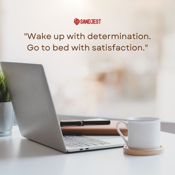 A laptop and a cup of coffee on a desk signify daily motivation for achieving work goals.