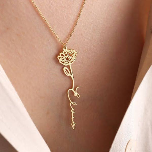 A dainty name necklace with a birth flower charm, the perfect personalized gift for your boyfriend's mom, designed to celebrate her unique style and personality.