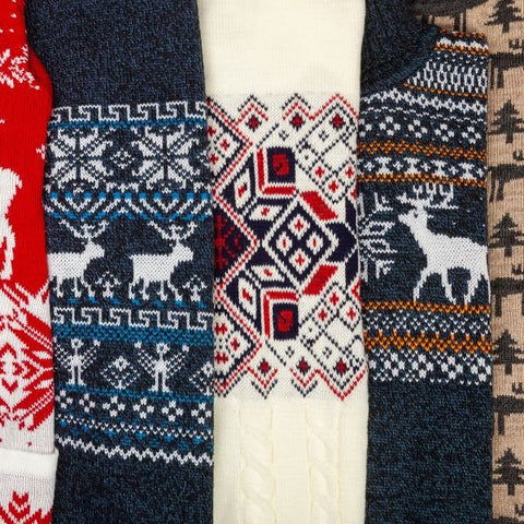 Hands carefully selecting the perfect plain sweater to customize for an Ugly Christmas Sweater Day masterpiece.