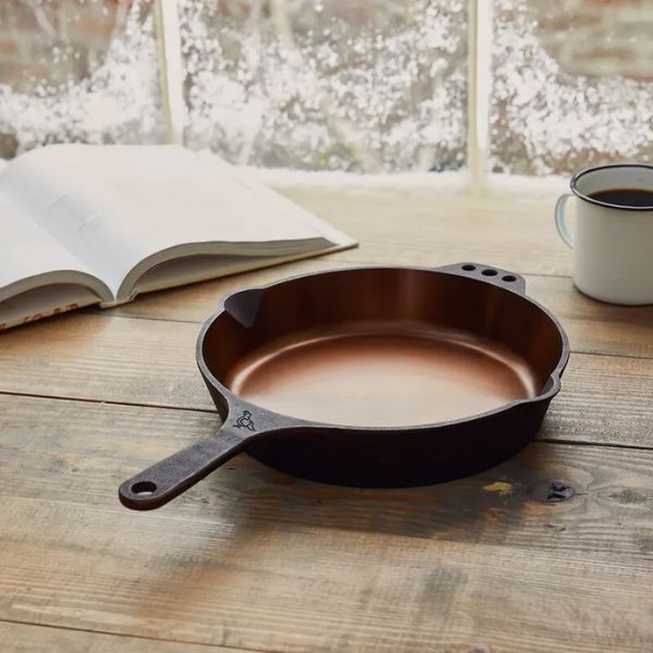 A personalized engraved cast iron skillet makes a thoughtful Christmas gift for couples who enjoy cooking together.