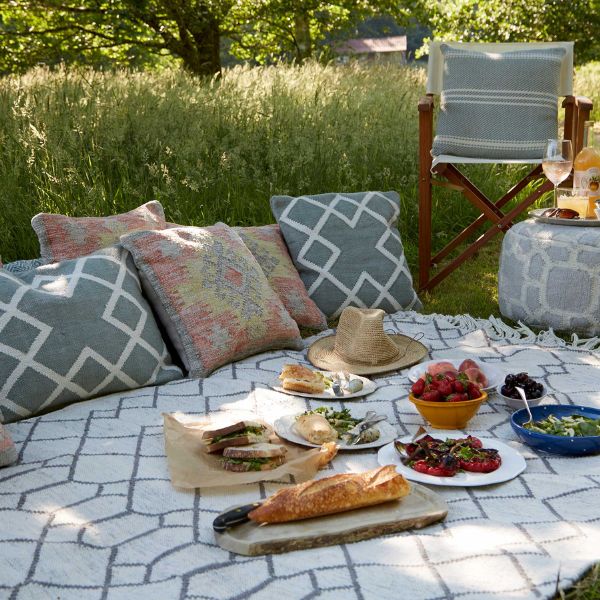 A cozy garden picnic setup with games, perfect for a relaxed birthday gathering.