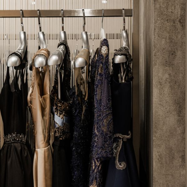 Elegant evening dresses hanging on a rack in a fashion boutique.