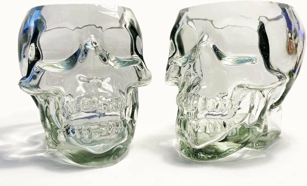 Clear glass sculpted skull glasses with intricate details