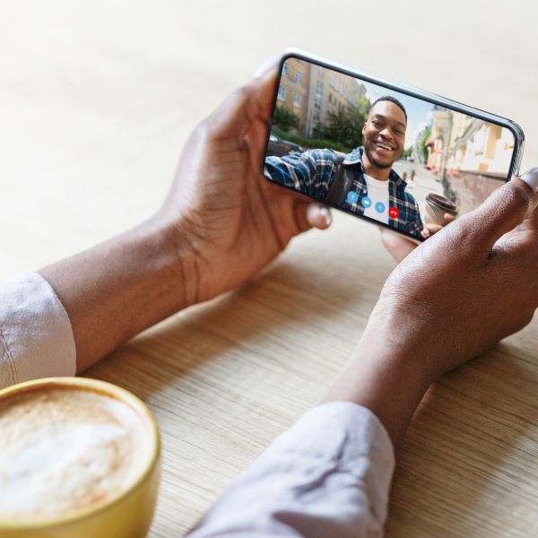 Smiling person enjoying a group video call with a surprise guest.