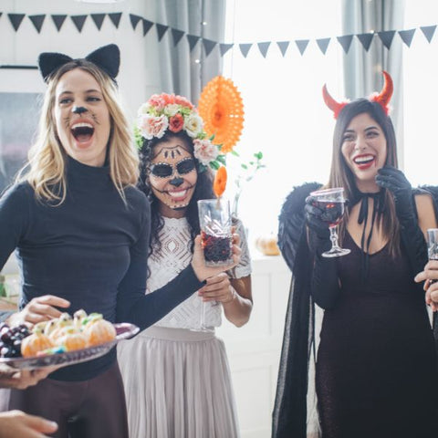 Joyful group in costumes at a vibrant Halloween party