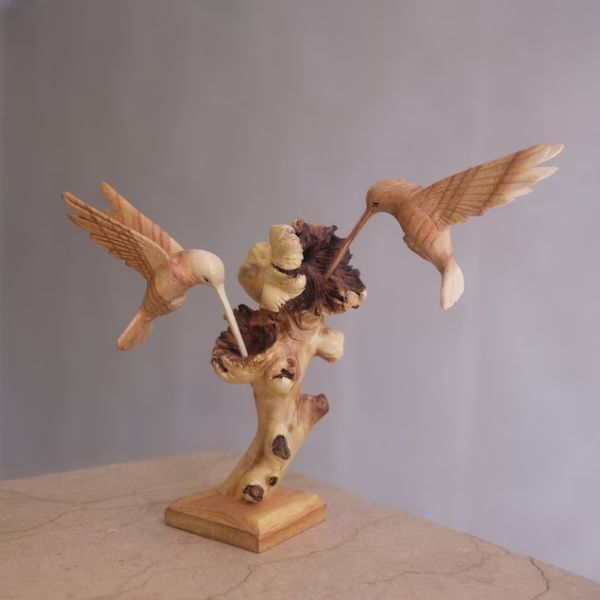 Hand Carved Wood Hummingbird Sculpture adds rustic charm to any room.