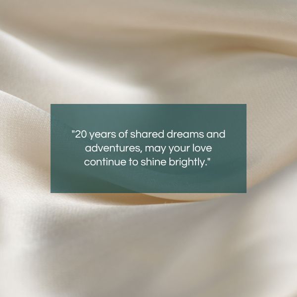"20 years of shared dreams and adventures, may your love continue to shine brightly." displayed on an elegant satin background.
