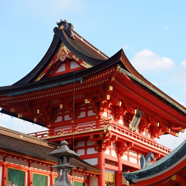 Traditional red Japanese temple structure against a blue sky