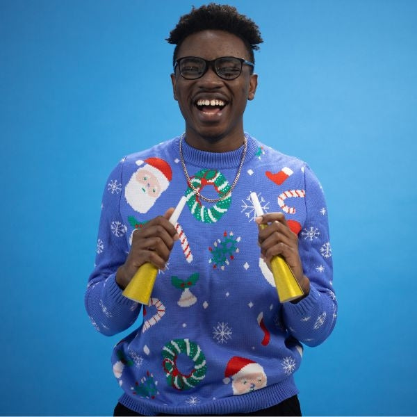 A triumphant individual adorned with a prize-winning ugly Christmas sweater