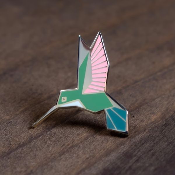 Show your love for hummingbirds with the Hummingbird Enamel Pin.