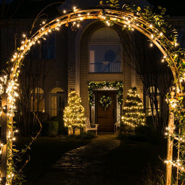 Sparkling christmas light decorations enhancing a gateway with colorful, festive brilliance.