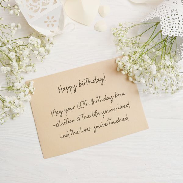 Classy handwritten birthday card on a floral background, commemorating 60th year with grace.