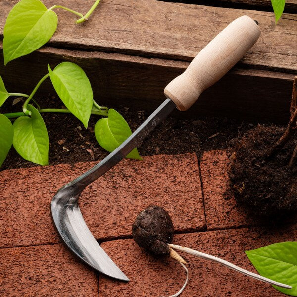 Japanese weeding sickle with a sharp edge, an efficient and unique gardening gift for moms dedicated to maintaining their gardens.
