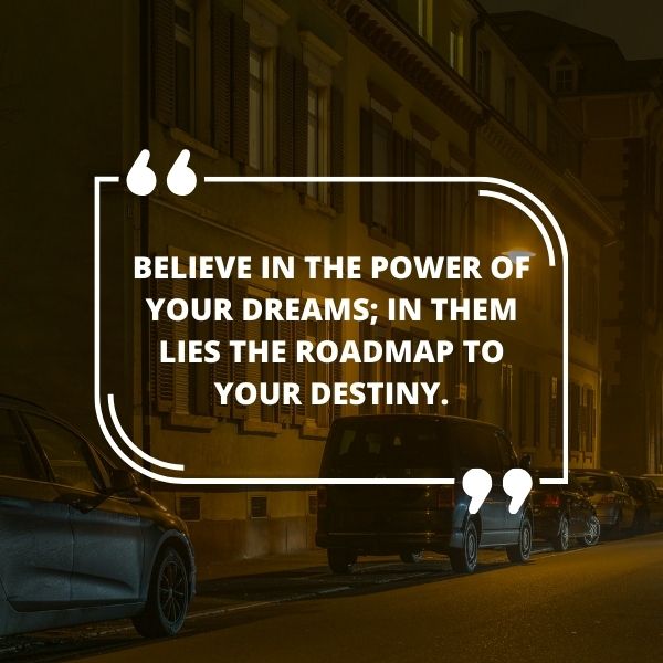 City street at night with a motivational life quote on believing in dreams