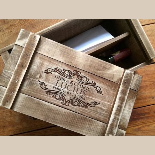 An engraved wooden wine box with a couple's names and date commemorating a special occasion representing a personalized and cherished keepsake.
