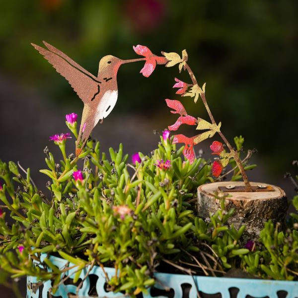 Metal Ruby-Throated Hummingbird Sign celebrates the vibrant world of hummingbirds.