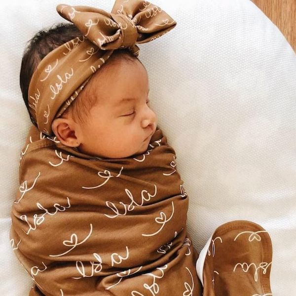 Personalize your baby girl's wardrobe with the Minky Swaddle Gown Knot Hat Bow and Personalized Name Blanket set.