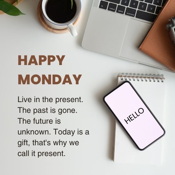 Motivational Monday quote about living in the present with a cozy workspace including a notepad, coffee, and smartphone