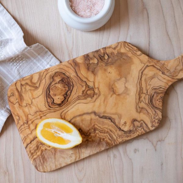 An Olive Wood Cutting Board, a sophisticated option in our gifts for a stay at home mom article, adds elegance to her kitchen.