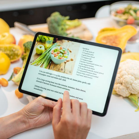 Person following an online cooking class on a tablet.