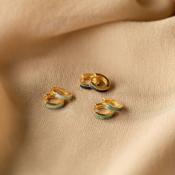 Opal Inlay Huggie Earrings are a radiant choice for 50th anniversary gifts, reflecting a lifetime's journey.