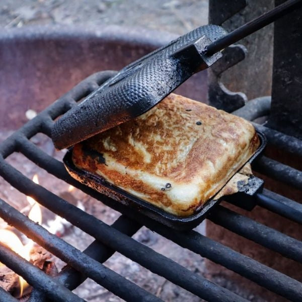 A cast iron outdoor pie iron, perfect for creating delicious campfire meals, an ideal choice for outdoor gifts for dads
