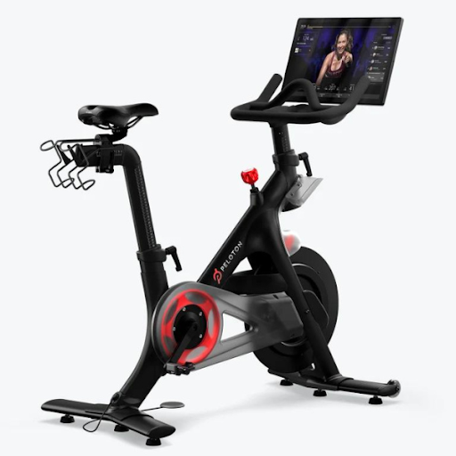 Image of the Peloton Bike, a premium exercise bike, offering a high-energy workout experience, a top choice among gifts for sports moms.