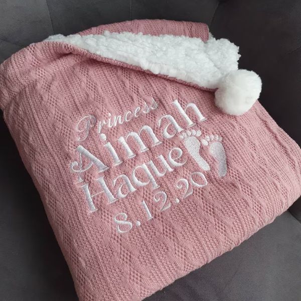 Snuggle up in warmth with the Personalized Knit Baby Blanket on Baby Day.
