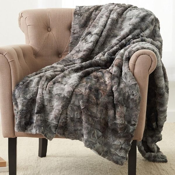 Pinzon Faux Fur Throw Blanket draped elegantly, a luxurious mothers day gifts for grandma.