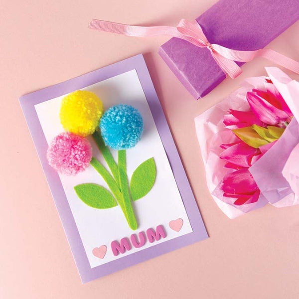 A Mother's Day card adorned with colorful pom poms.