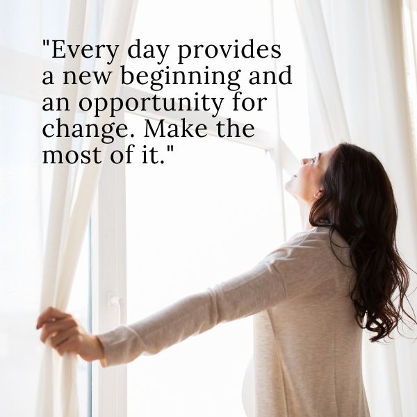 Woman opening curtains to a new day symbolizing new beginnings and change