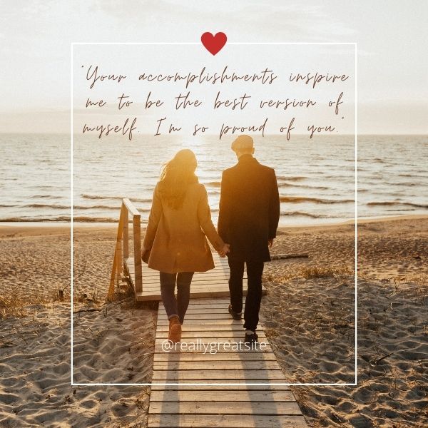 Couple walking hand in hand on a beach boardwalk with an inspiring love quote.