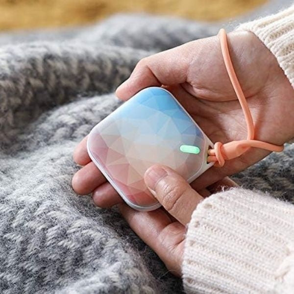 Portable rechargeable hand warmer, keeping grandma cozy during cold days.