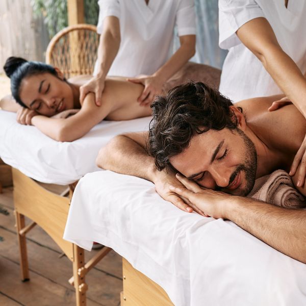 Couple receiving a relaxing back massage at a wellness spa.