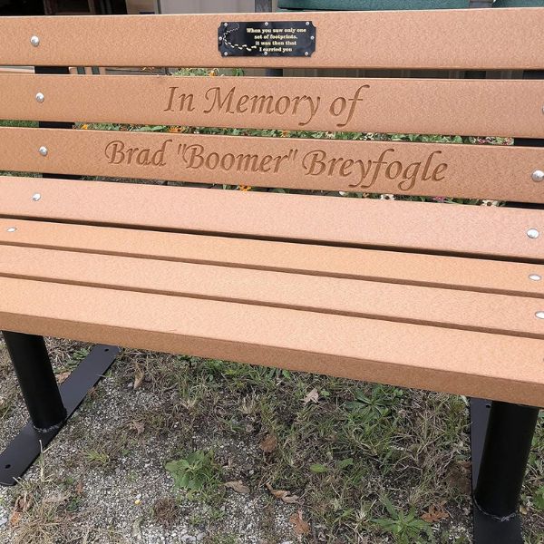 Memorial bench with engraved message plaque, a lasting pet tribute for outdoor spaces.