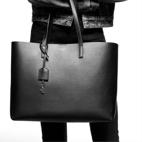 Carry your love with her every day with the Saint Laurent Shopping Leather Tote, a sophisticated and practical anniversary gift for your wife.
