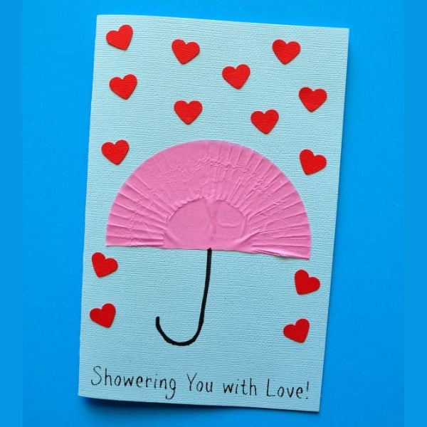 A Mother's Day card with a paper umbrella and heart raindrops.