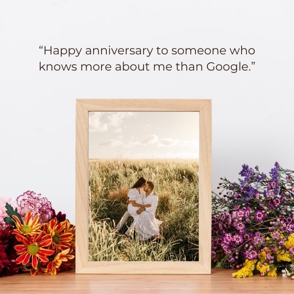 Anniversary quote beside a photo frame and flowers