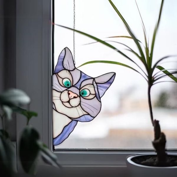 Let the festive sunlight dance with the Stained Glass Cat Suncatcher.
