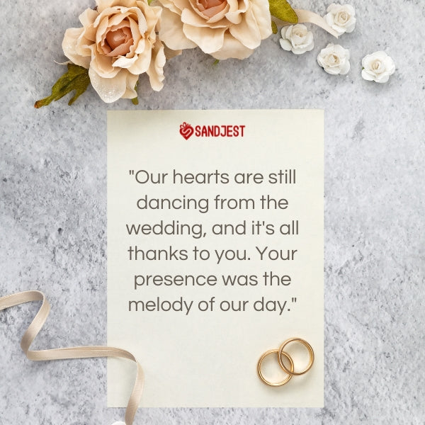 Elegant wedding thank you card with roses and wedding rings, featuring a message from SANDJEST.