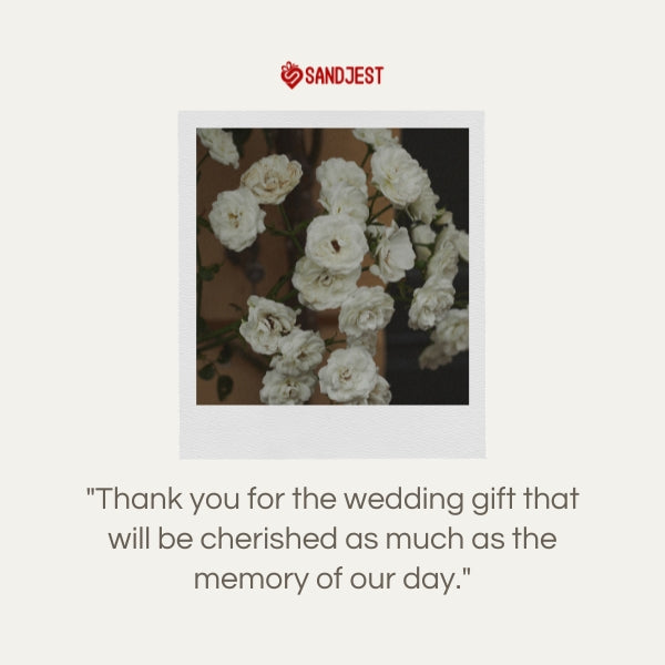 A SANDJEST thank you card placed among delicate white flowers for a wedding gift.