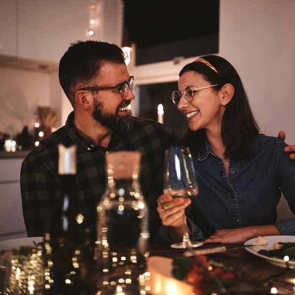 Couple enjoying a private dinner with candles and wine.