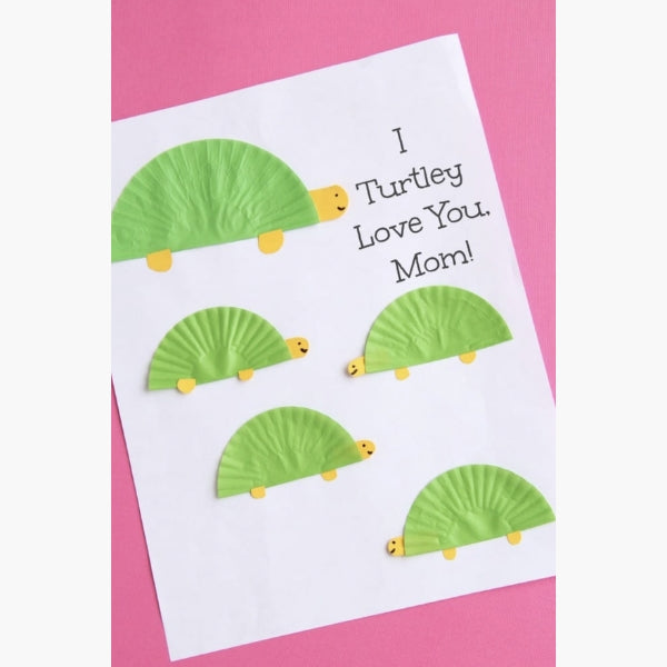 A card featuring cute paper turtle shapes with the pun "I Turtley Love You, Mom!"