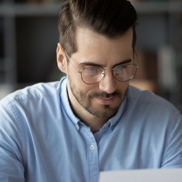 A man looks at his birthday messages, showcasing your thoughtful efforts.